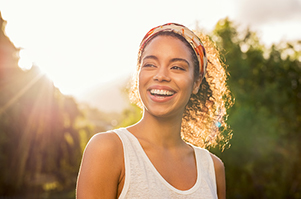 Beautiful Black woman smiling after getting her teeth whitened in Myers Park Dental Partners in Charlotte, NC