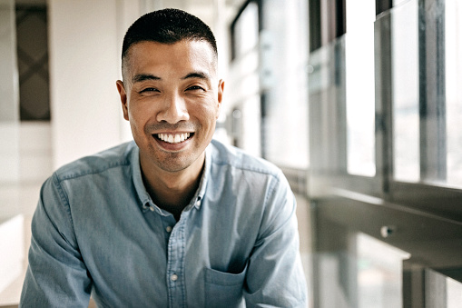 Man in light blue shirt smiling 